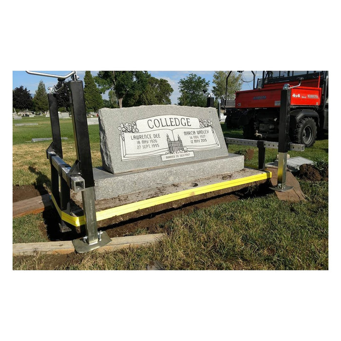 Tombstone Jack lifting a granite headstone with a yellow strap under the stone